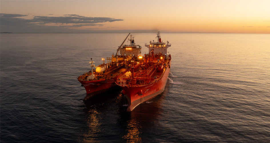 Navigator Global and the Green Pioneer at dusk at the outer anchorage of Port Dampier